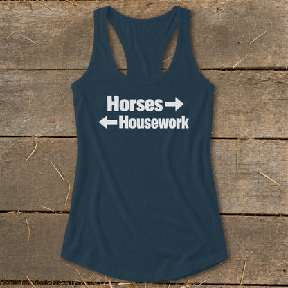 Dark blue women's racerback tank top featuring the white text "Horses" with a right arrow and "Housework" with a left arrow.