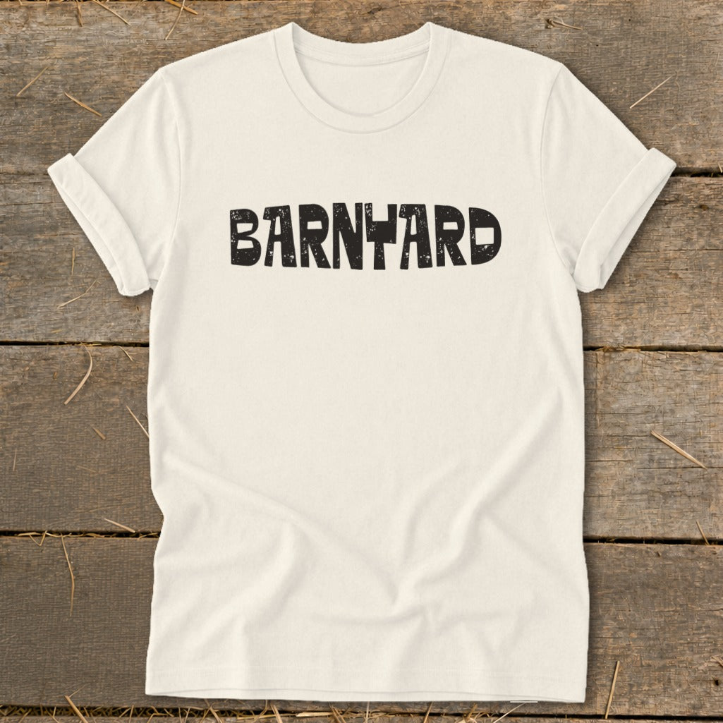 A cream-colored short-sleeved t-shirt with the word "BARNYARD" printed in distressed black block letters across the chest.
