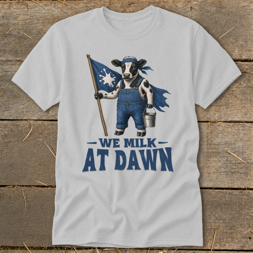 Cow in overalls and cape holding a flag with text "WE MILK AT DAWN".