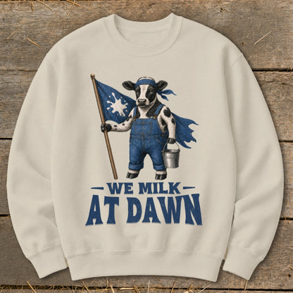 Cow in overalls holding a milk splash flag and pail, "We Milk At Dawn" text.