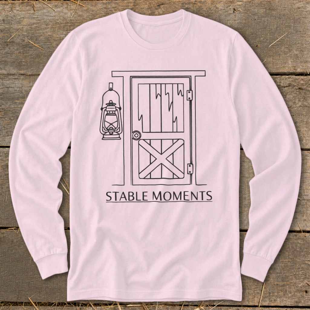 Pink long-sleeve shirt with a line drawing of a barn door, lantern, and text "STABLE MOMENTS".
