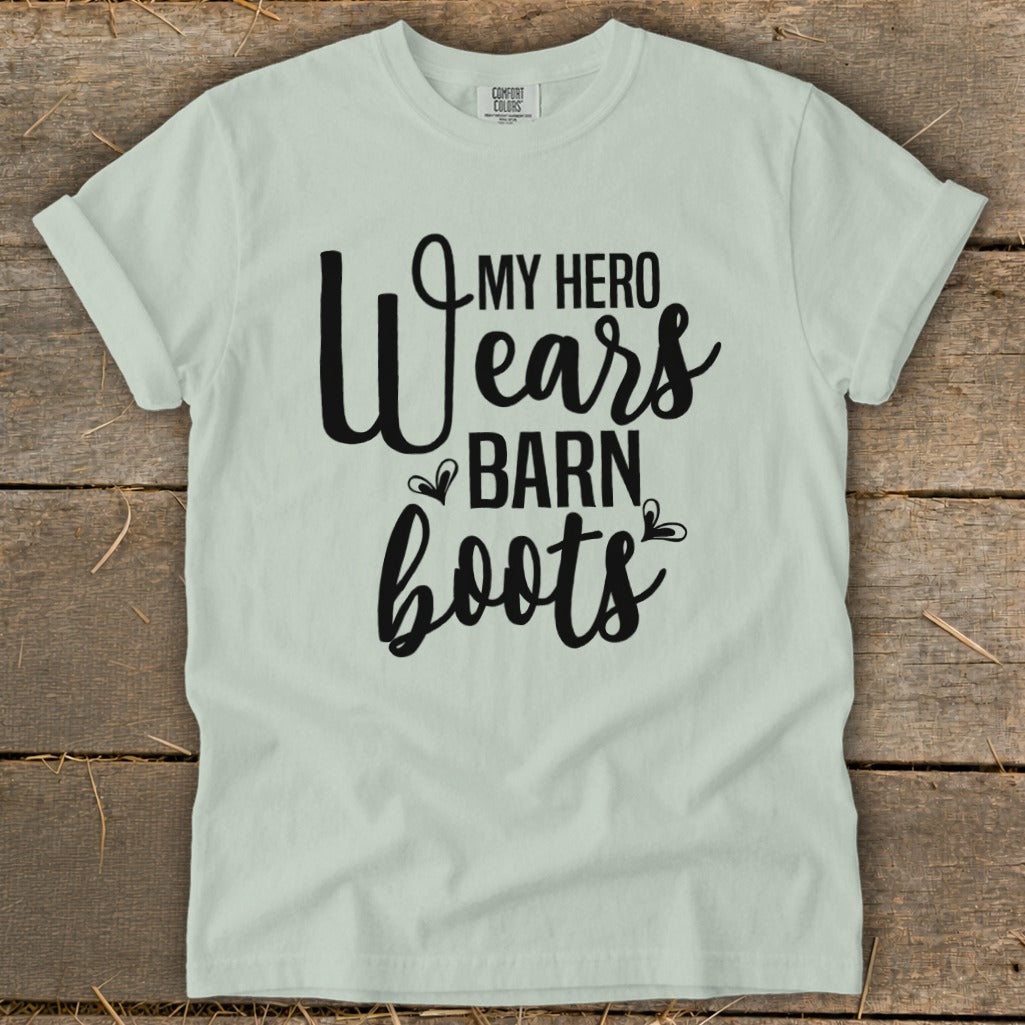Light green t-shirt with "My Hero Wears Barn Boots" graphic in black lettering.