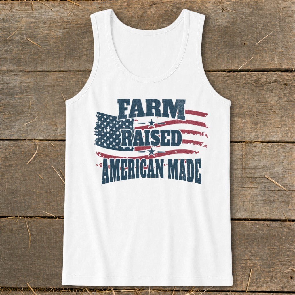 White tank top with "FARM RAISED AMERICAN MADE" in distressed text over an American flag design.