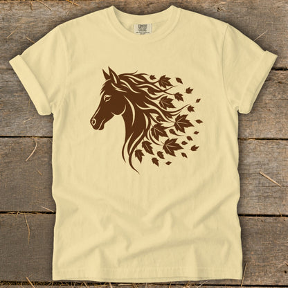 Yellow t-shirt with a brown horse head silhouette with flowing mane made of autumn leaves.