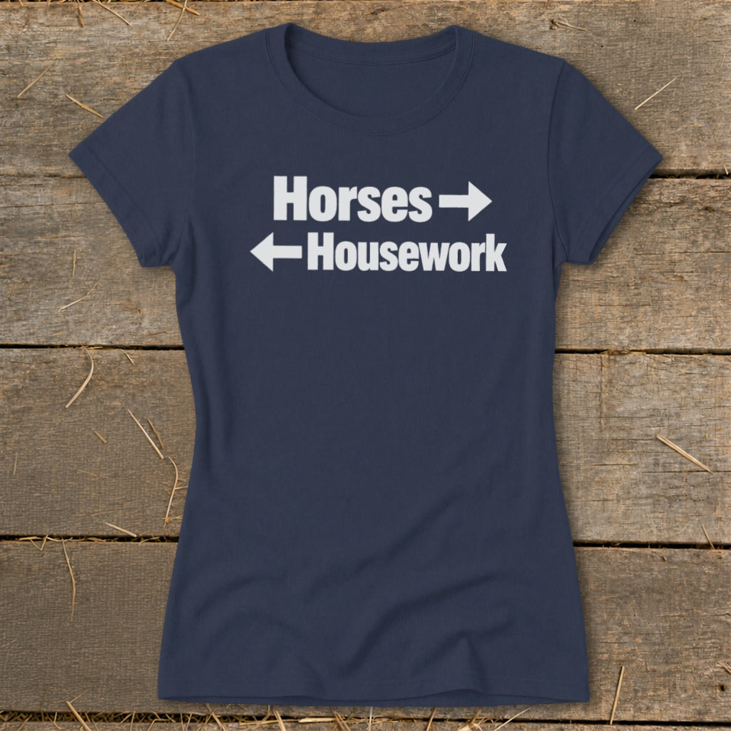 Dark blue women's t-shirt featuring the white text "Horses" with a right arrow and "Housework" with a left arrow.