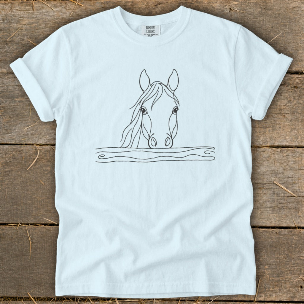 White t-shirt with line drawing of a horse's head peeking over a wooden fence.