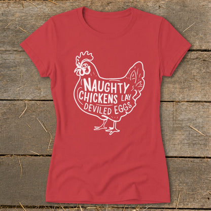 Red t-shirt with white graphic of a chicken and text "Naughty Chickens Lay Deviled Eggs".