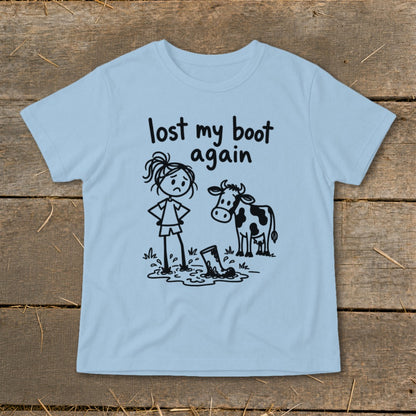 Light blue t-shirt featuring a stick figure graphic of a girl, cow, and muddy boot with the text "lost my boot again."