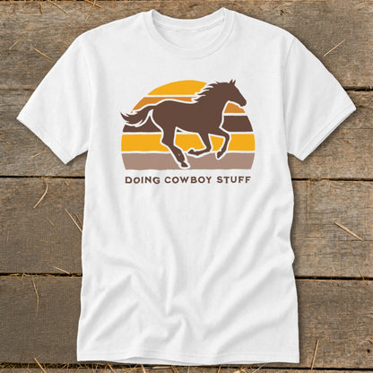 White t-shirt with brown horse silhouette and text "DOING COWBOY STUFF".