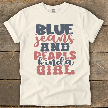 Cream t-shirt with "BLUE JEANS AND PEARLS kinda GIRL" text graphic.