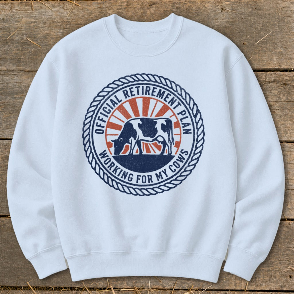 White sweatshirt with "Official Retirement Plan Working for My Cows" text and a cow graphic.