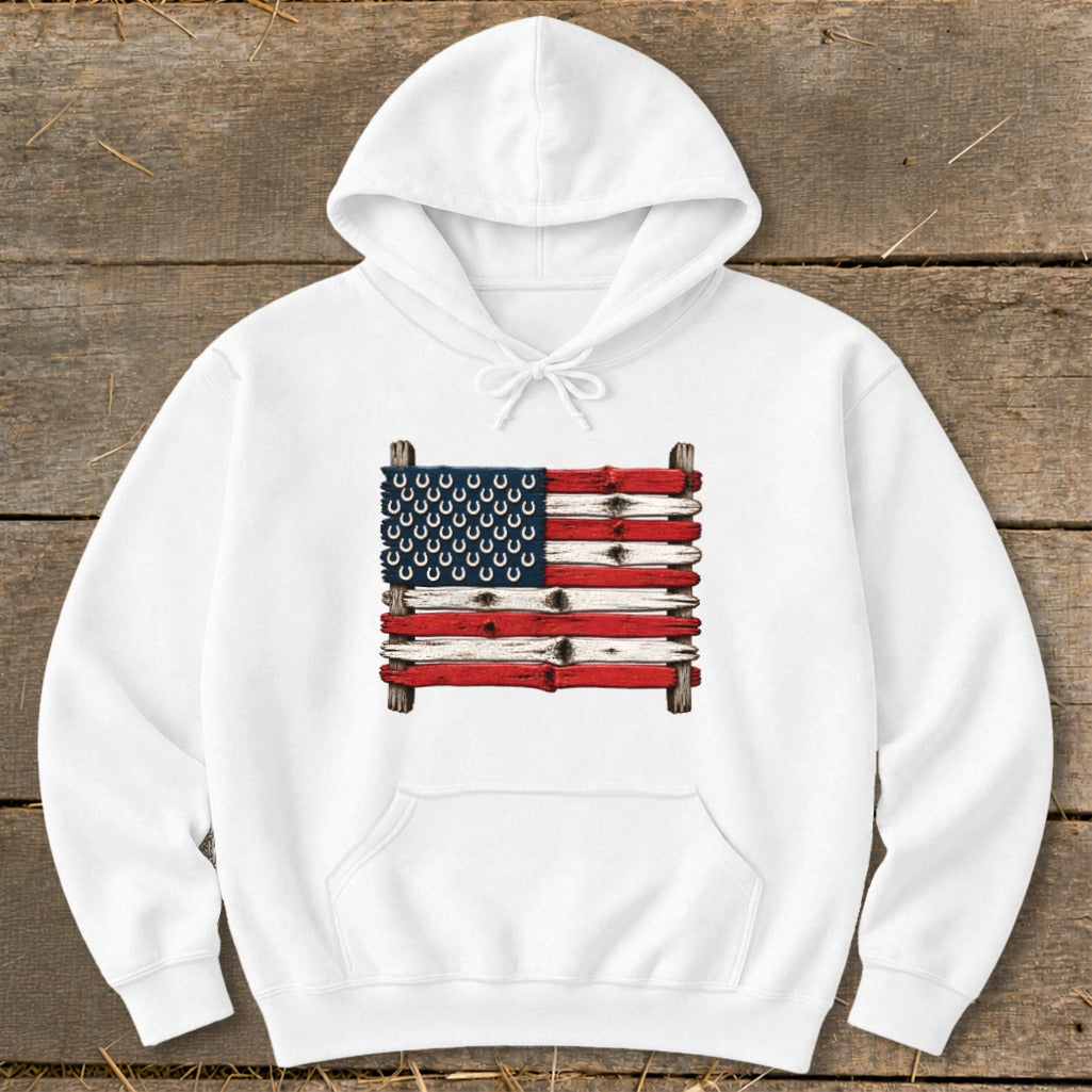 A white hooded sweatshirt features a graphic of an American flag made from weathered wooden boards and horseshoes.