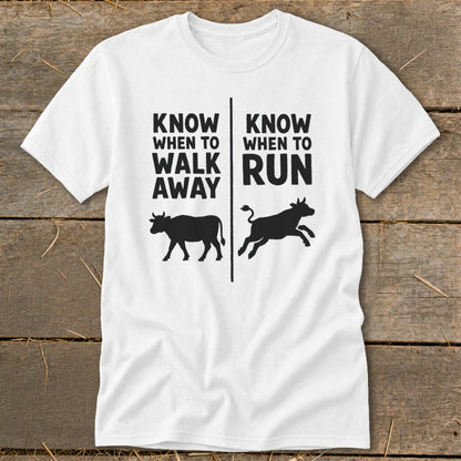 White t-shirt with text "Know When to Walk Away" and "Know When to Run" and cow graphics.