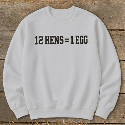 Light gray crewneck sweatshirt featuring the black distressed text 12 HENS = 1 EGG on the chest.