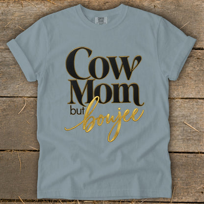 Light blue t-shirt with "Cow Mom but boujee" text in black and gold lettering.