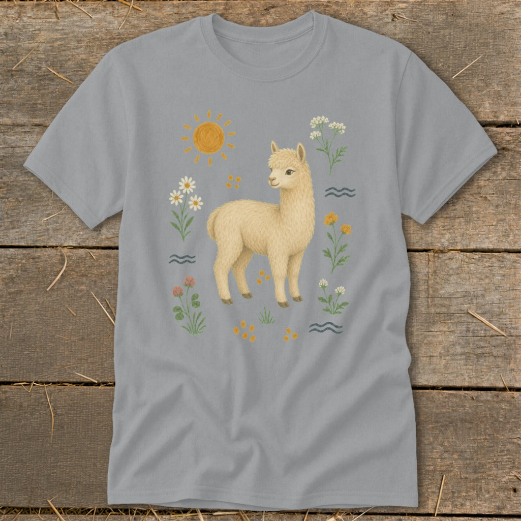 Grey t-shirt with a cream alpaca surrounded by flowers, sun, and wavy lines.