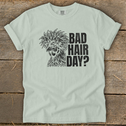Light green t-shirt with black graphic of a chicken and text "BAD HAIR DAY?".