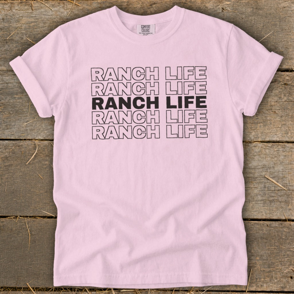 Light pink t-shirt featuring the text Ranch Life printed in bold, repeating black block letters across the chest.