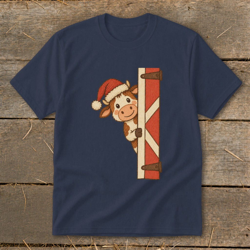 Navy t-shirt with a cartoon cow wearing a Santa hat peeking from behind a red barn door.