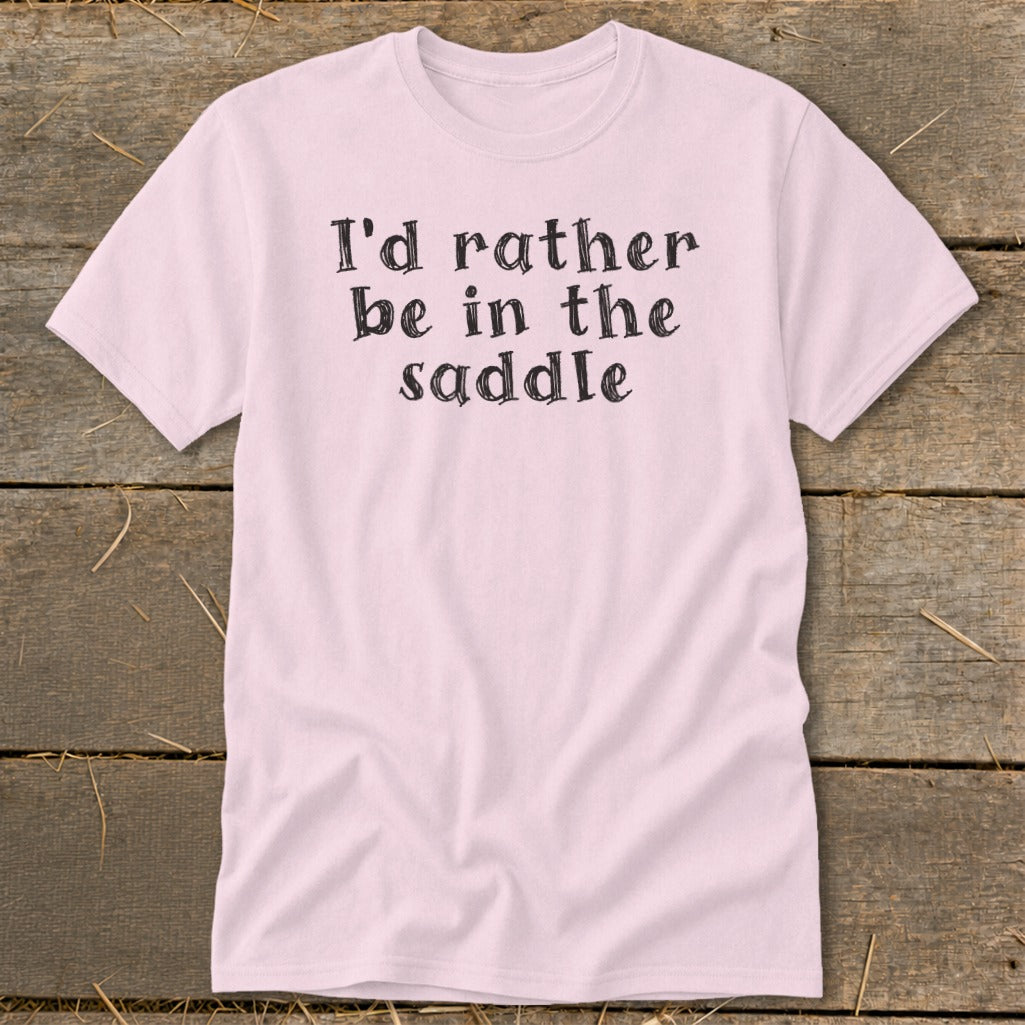 Pink t-shirt with black text that reads "I'd rather be in the saddle."