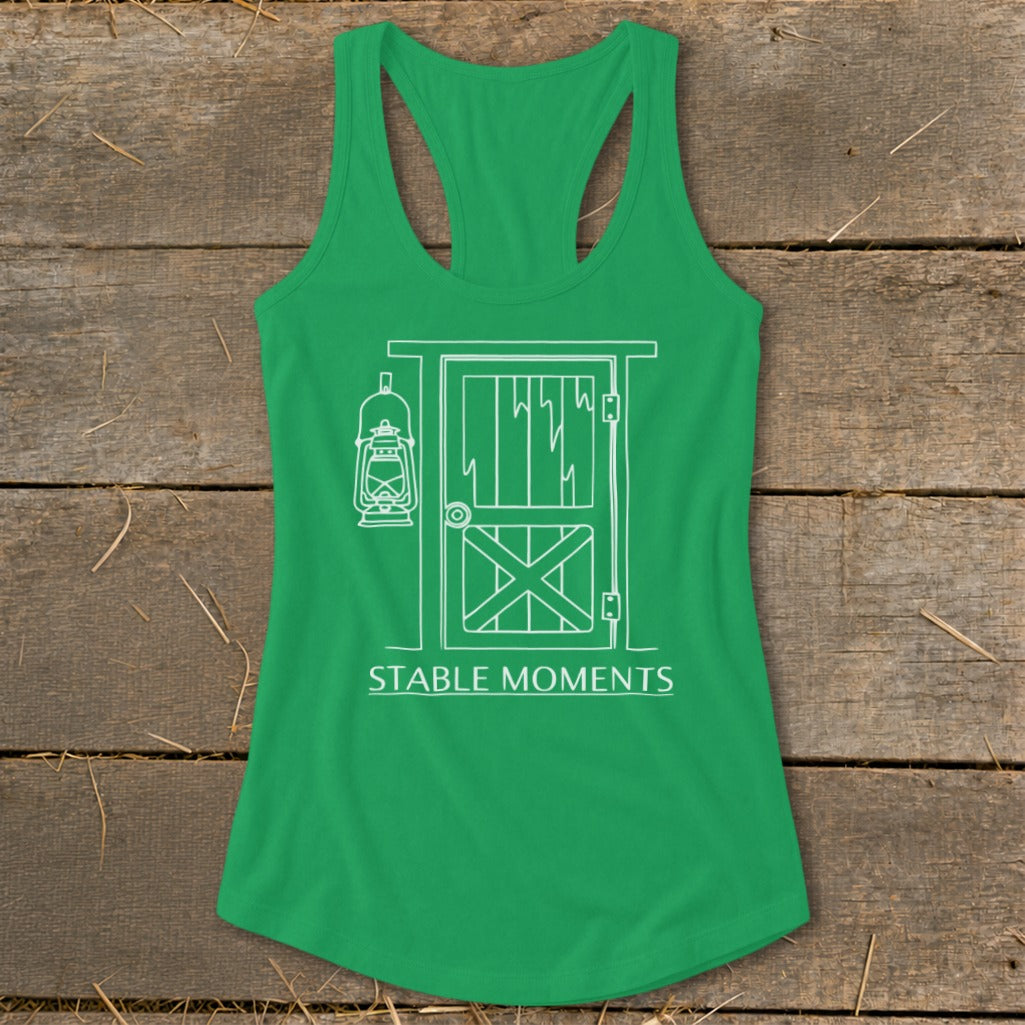 Green tank top with white line drawing of a barn door and lantern. "Stable Moments" text below.
