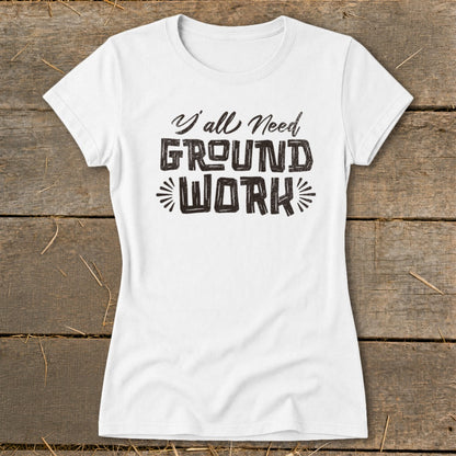 White t-shirt with distressed black text reading "Y'all Need GROUND WORK".