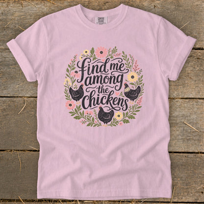 Light pink t-shirt with floral circle design and text "Find me among the chickens".