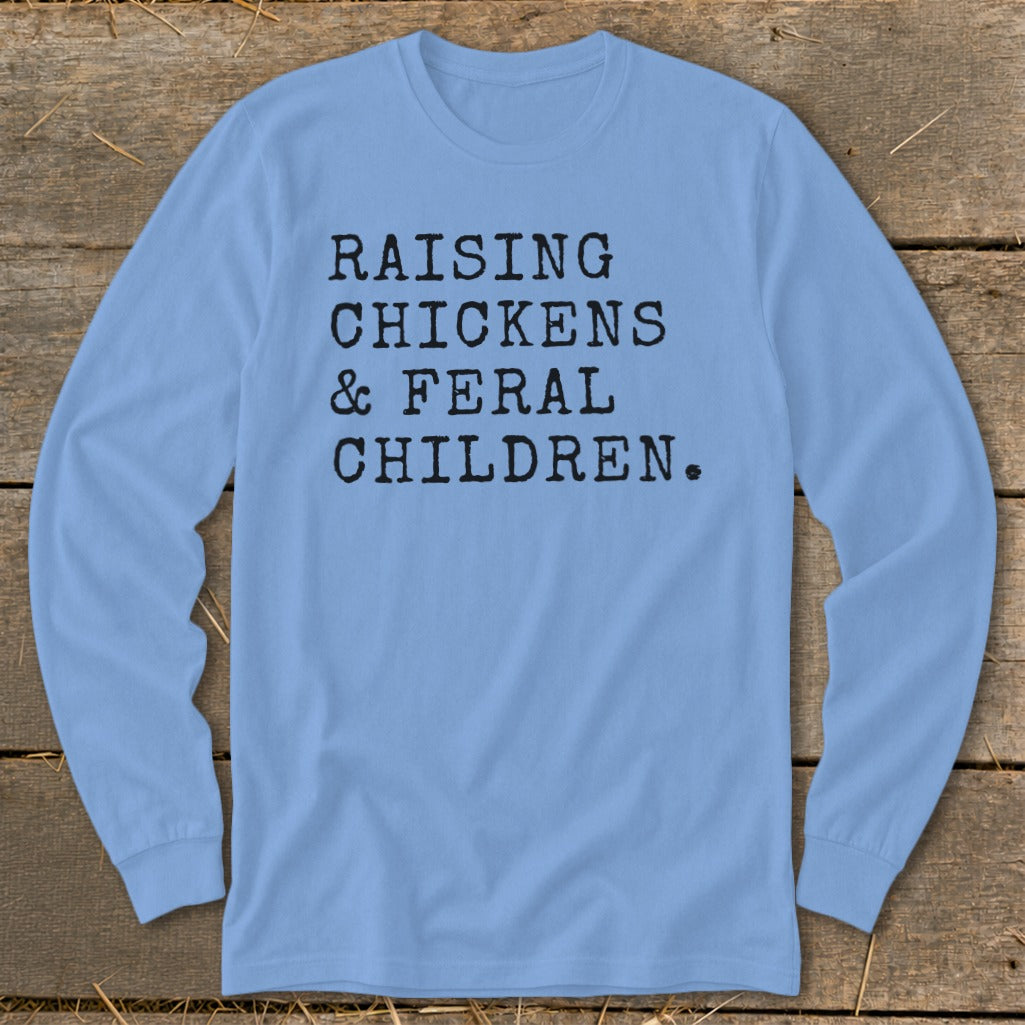 Light blue long sleeve shirt with black text reading "RAISING CHICKENS & FERAL CHILDREN."