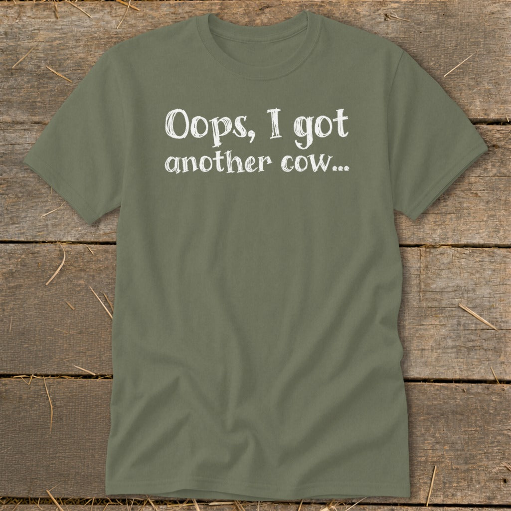 Olive green t-shirt with white text that reads "Oops, I got another cow..."