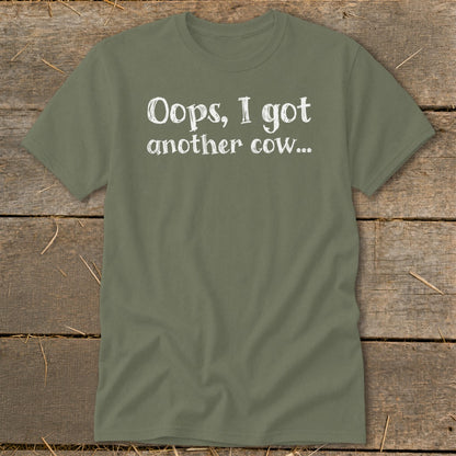 Olive green t-shirt with white text that reads "Oops, I got another cow..."