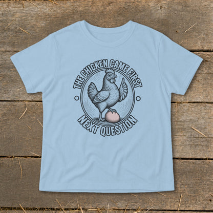 Light blue t-shirt with a chicken and egg graphic and text "The chicken came first, next question".