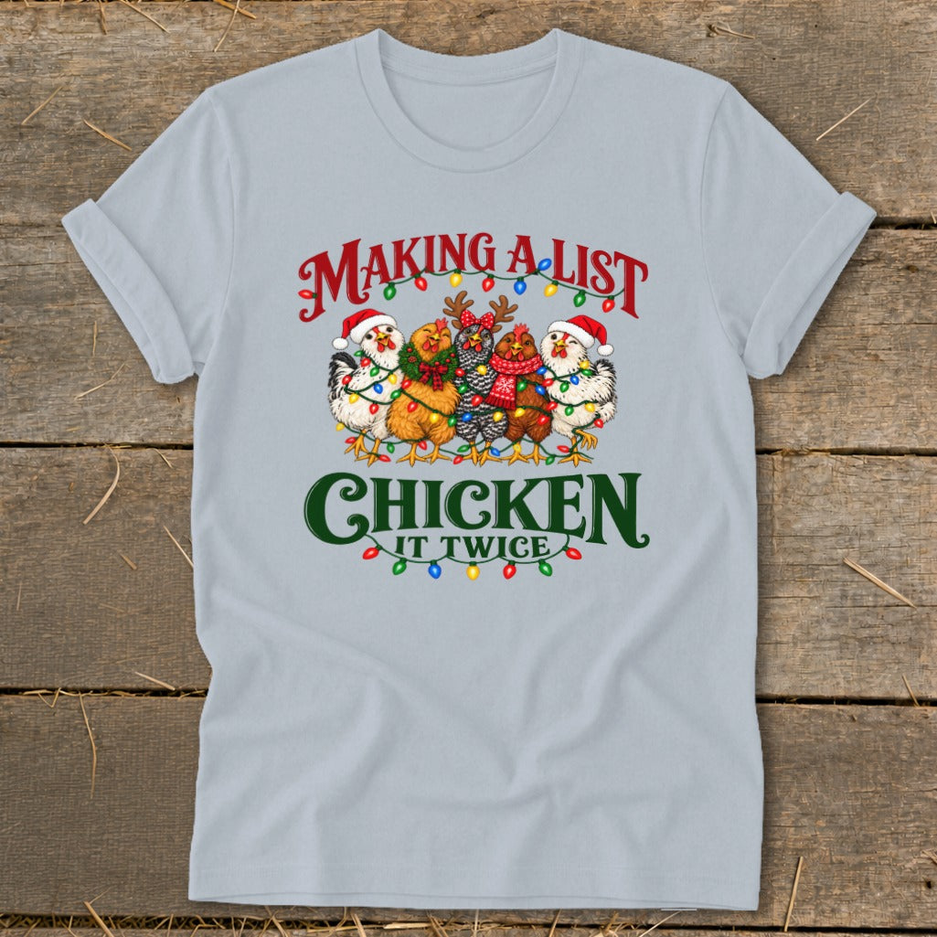 T-shirt with chickens wearing Santa hats and wrapped in Christmas lights. Text reads "Making a list chicken it twice".