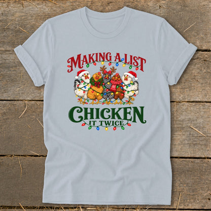 T-shirt with chickens wearing Santa hats and wrapped in Christmas lights. Text reads "Making a list chicken it twice".