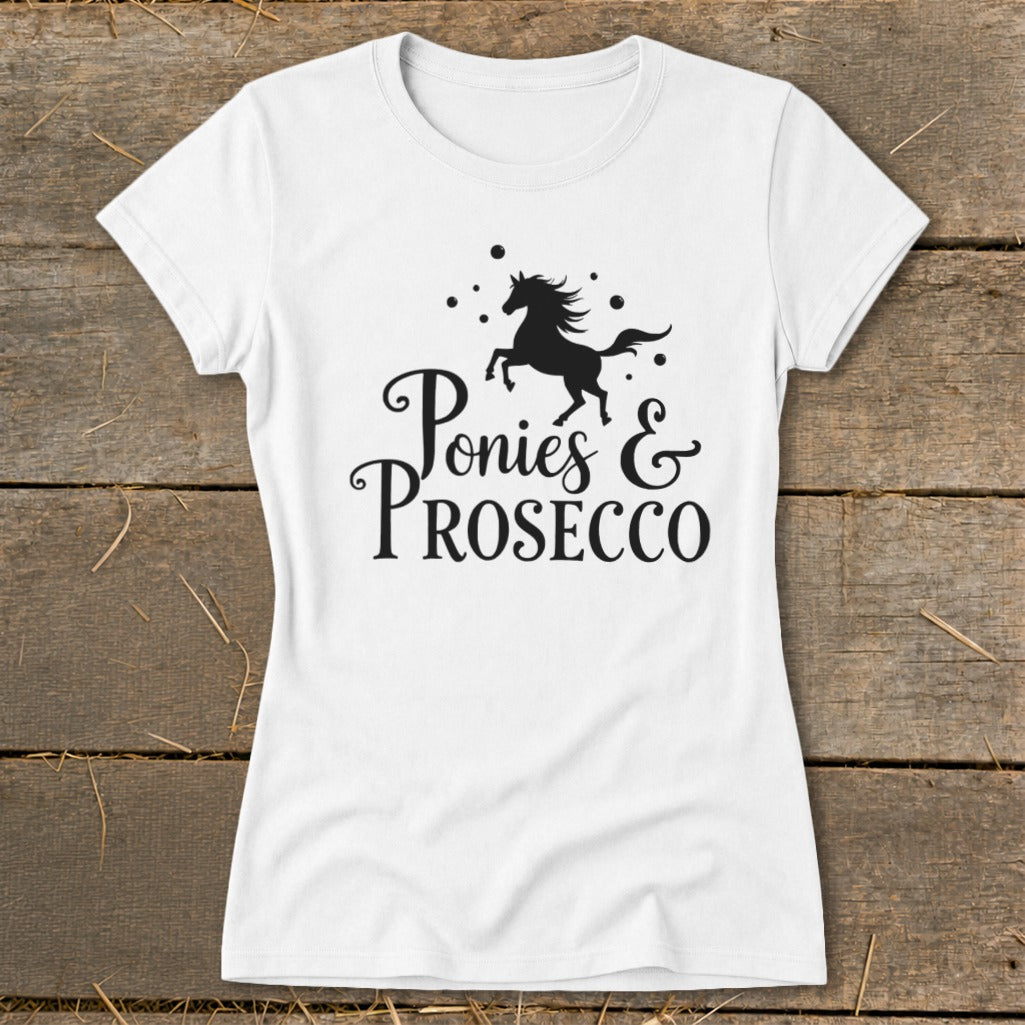 White t-shirt with black graphic of a running horse and text "Ponies & Prosecco".