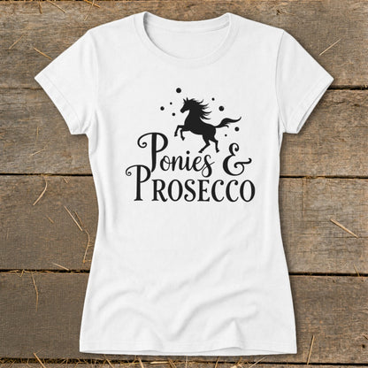 White t-shirt with black graphic of a running horse and text "Ponies & Prosecco".