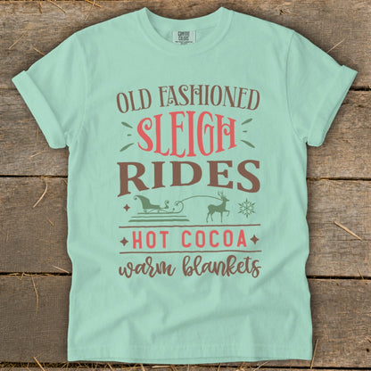 Mint t-shirt with "Old Fashioned Sleigh Rides Hot Cocoa Warm Blankets" text and graphics.