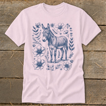 Pink t-shirt with a dark blue sketch of a donkey surrounded by flowers.
