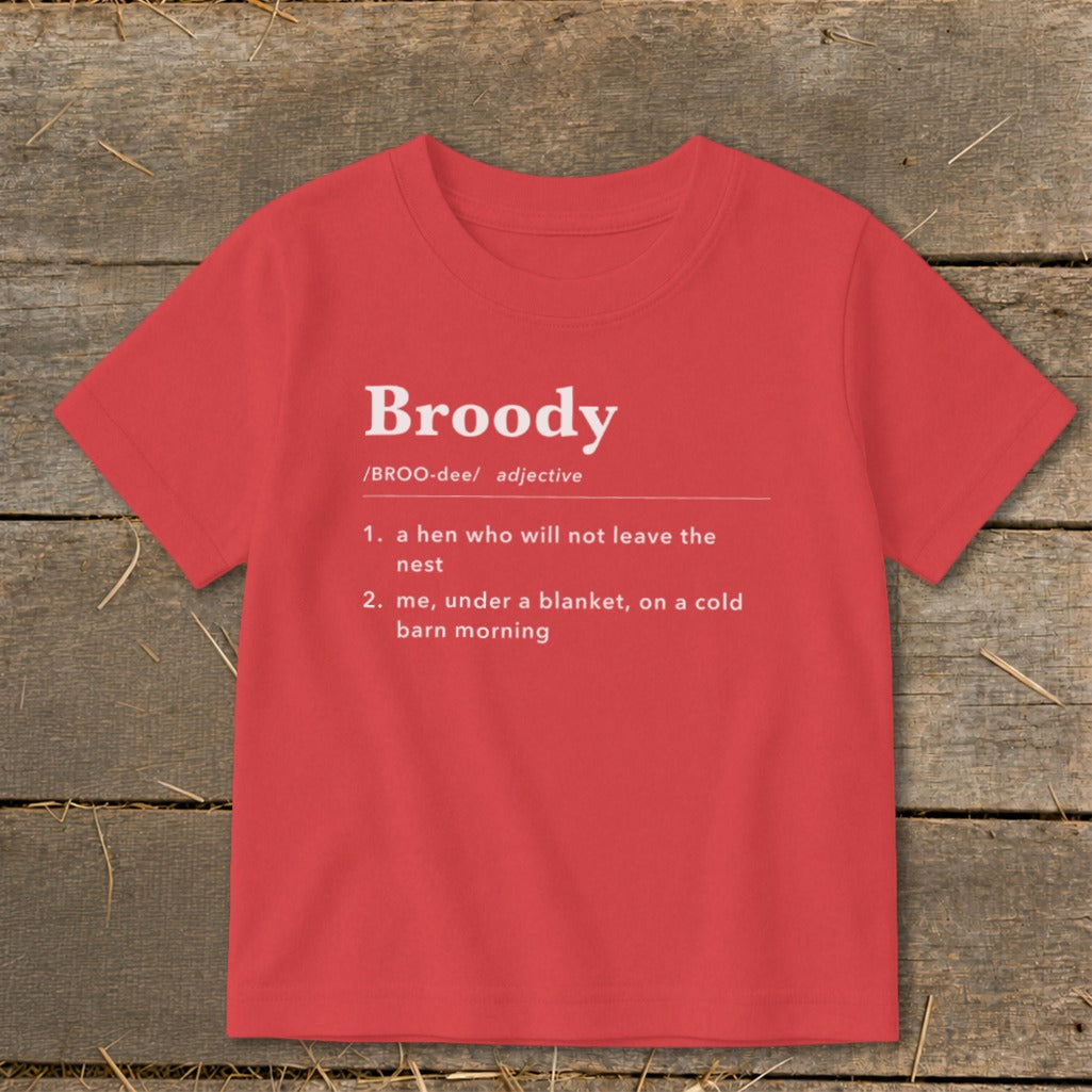 Red t-shirt with "Broody" definition: "a hen who will not leave the nest" and "me, under a blanket, on a cold barn morning".
