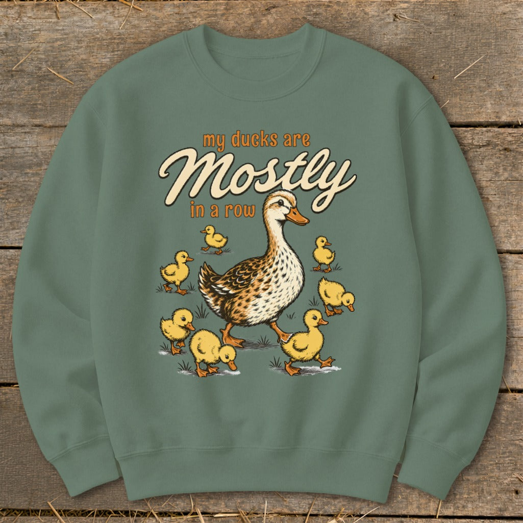 Adult duck with ducklings and text "my ducks are Mostly in a row."