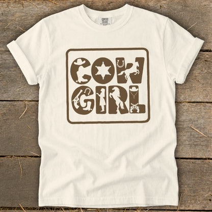 Cream t-shirt with brown "Cow Girl" graphic featuring Western-themed icons.