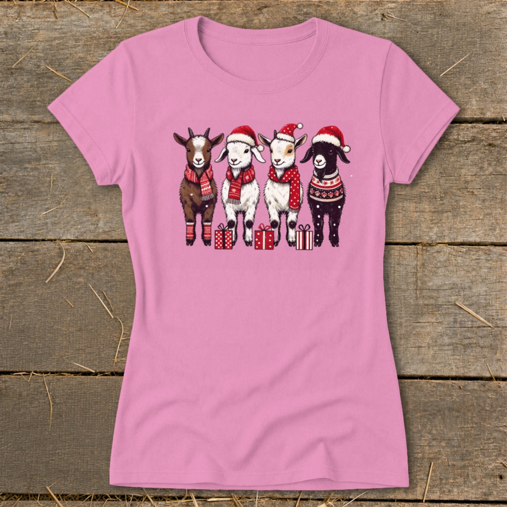 Four goats wearing Santa hats and scarves stand with presents.