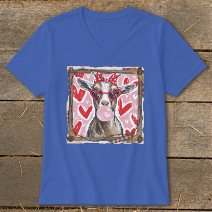 Goat wearing heart sunglasses and polka dot bow, blowing bubblegum on pink background with hearts.