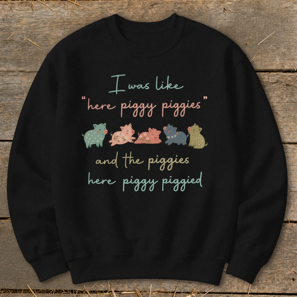 Black sweatshirt with "I was like "here piggy piggies" and the piggies here piggy piggied" text and pigs.