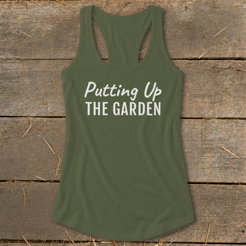 Olive green tank top with white text reading "Putting Up THE GARDEN".