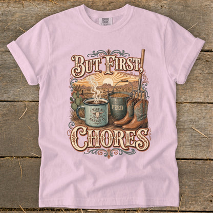 Pink t-shirt with "But First, Chores" graphic featuring boots, feed bucket, and coffee.