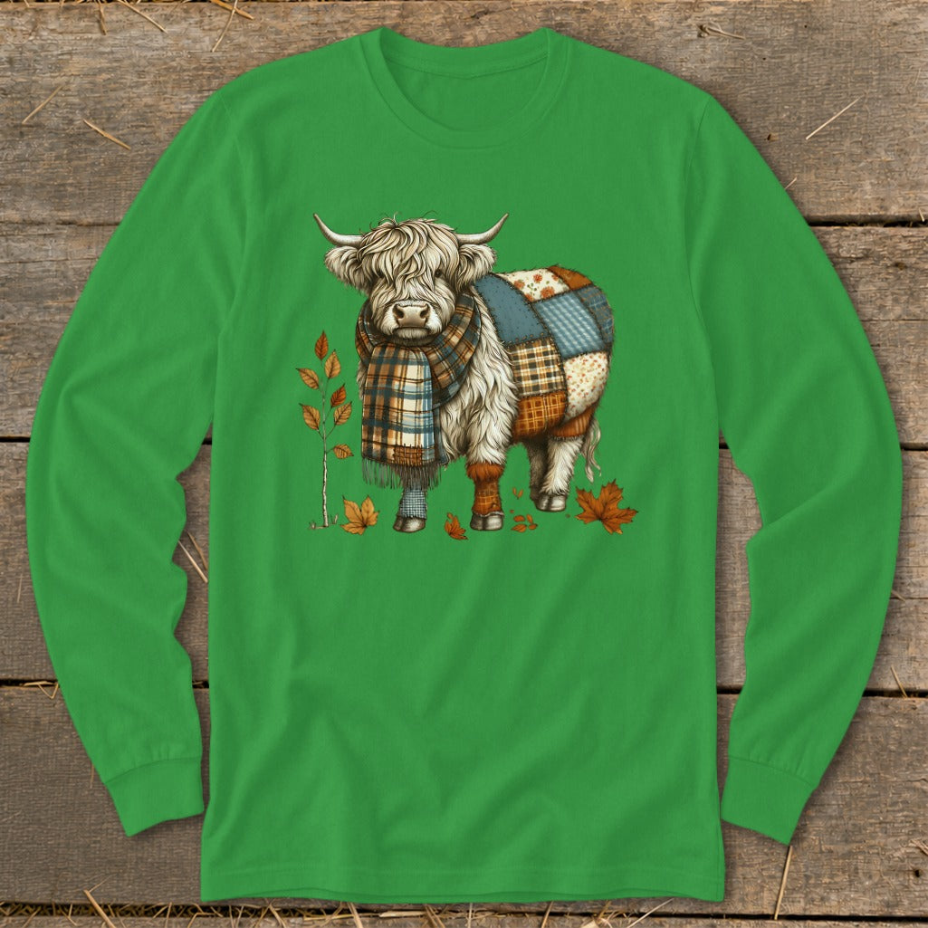 Highland cow with patchwork pattern on back, wearing scarf, surrounded by autumn leaves.