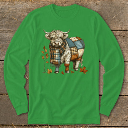 Highland cow with patchwork pattern on back, wearing scarf, surrounded by autumn leaves.