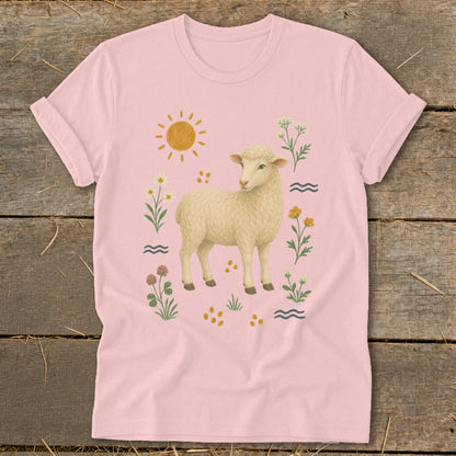 Pink t-shirt with a cream sheep illustration surrounded by flowers, sun, and waves.