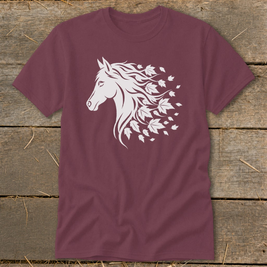 Maroon t-shirt with white horse head and flowing mane transforming into autumn leaves.