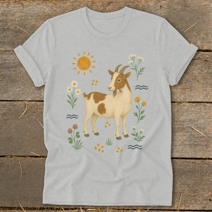 Light grey t-shirt with a cartoon brown and white goat surrounded by flowers and sun.